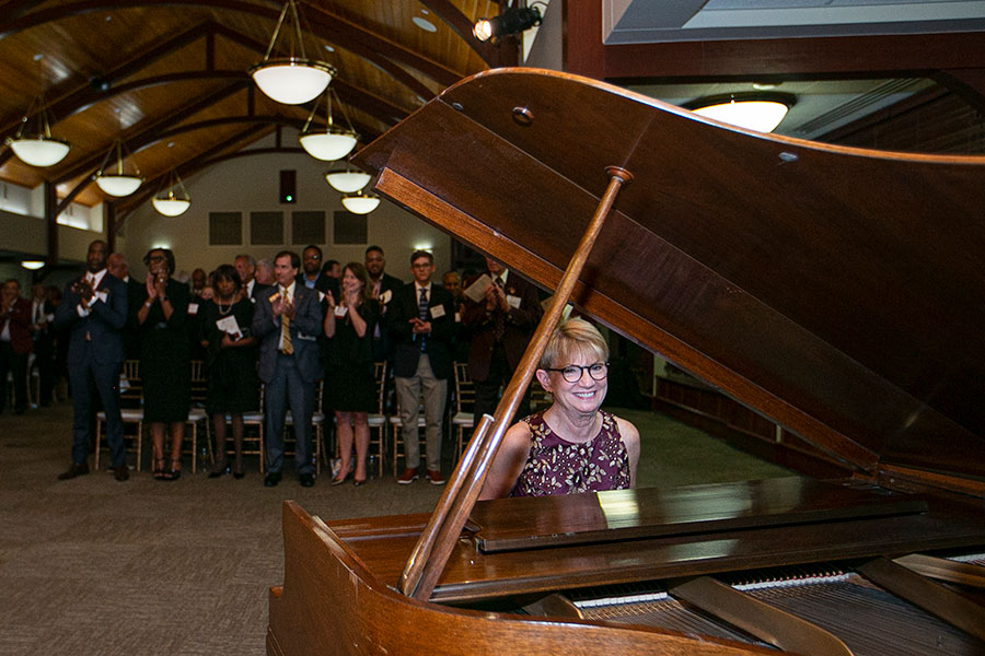 Mrs. Cottrell plays "Hymn of the Garnet and Gold" on the piano at an FSU event.