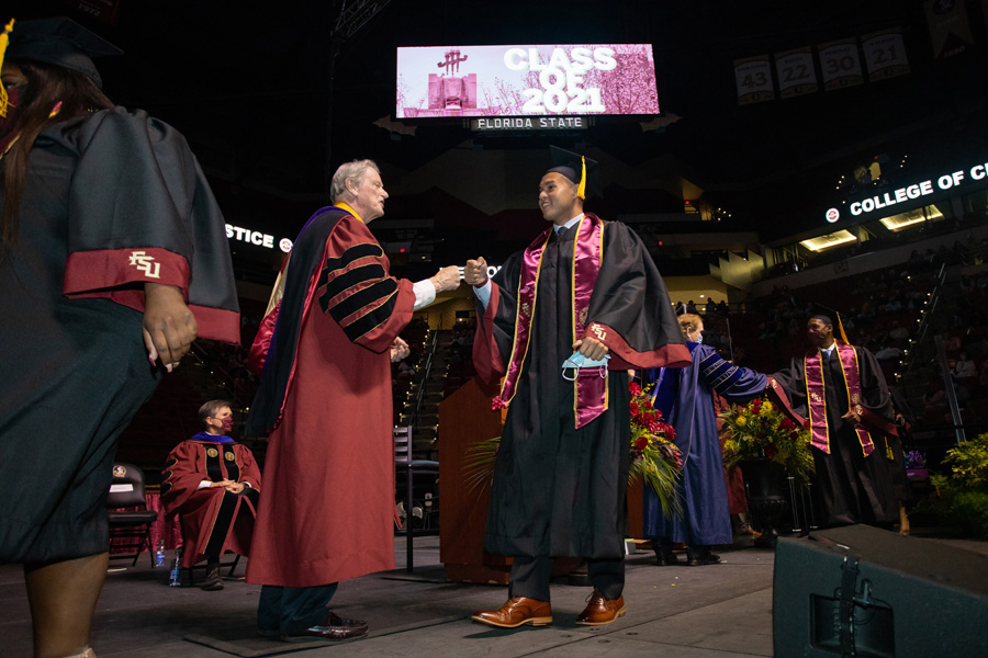 President Thrasher congratulates Brady Latchford, a member of the Seminole Tribe of Florida, on receiving his bachelor's degree during FSU Spring Commencement Friday, April 23, 2021. (FSU Photography Services)