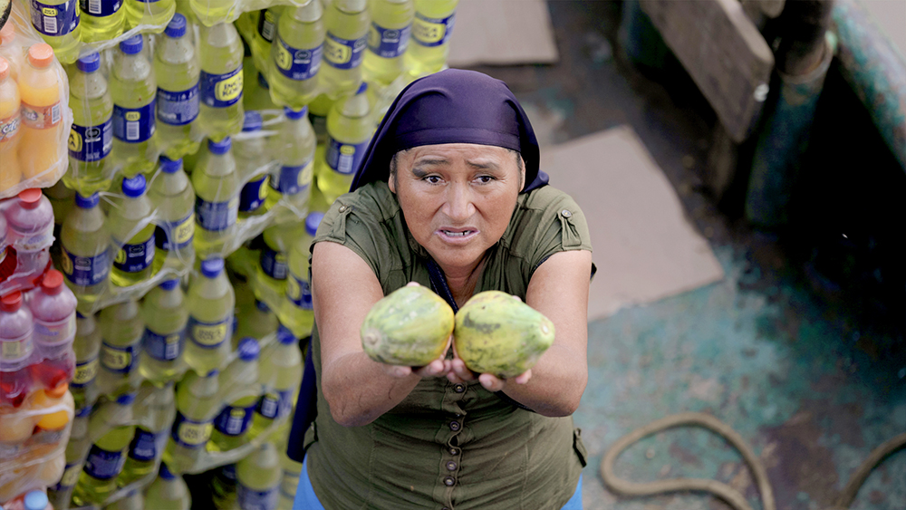 Marcos Colón, “Papaya for Sale,” a local women sells papayas in Nuevo Pebas, Peru, March 2020.