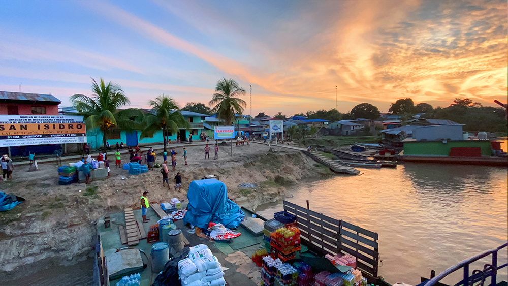 Marcos Colón, “Sunset in San Isidro,” villagers unload cargo from the ship in San Isidro, Peru, March 2020.