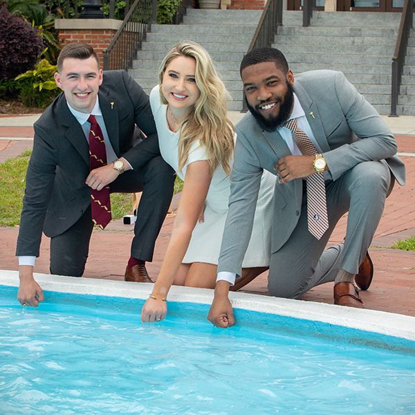 FSU graduates dip their class rings into Westcott Fountain during ring pick-up Thursday, April 8, 2021. (FSU Photography Services)