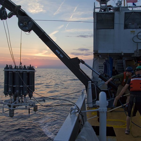 Researchers on the NOAA ship Nancy Foster recovering a CTD instrument that is used to collect water samples and algae from multiple depths in the ocean. (Courtesy of Michael Stukel)