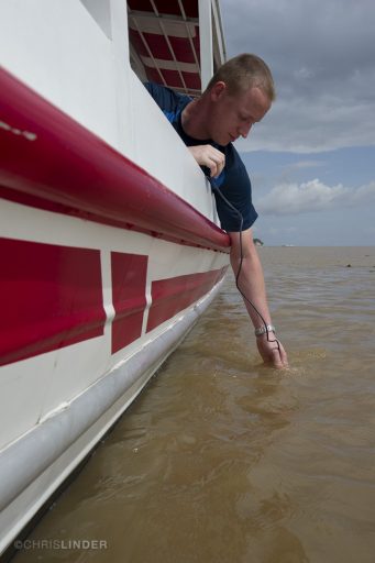 Rob Spencer, an associate professor in FSU's Department of Earth, Ocean and Atmospheric Science, takes a sample in the Amazon River near Óbidos, Brazil. (Photo by Chris Linder)
