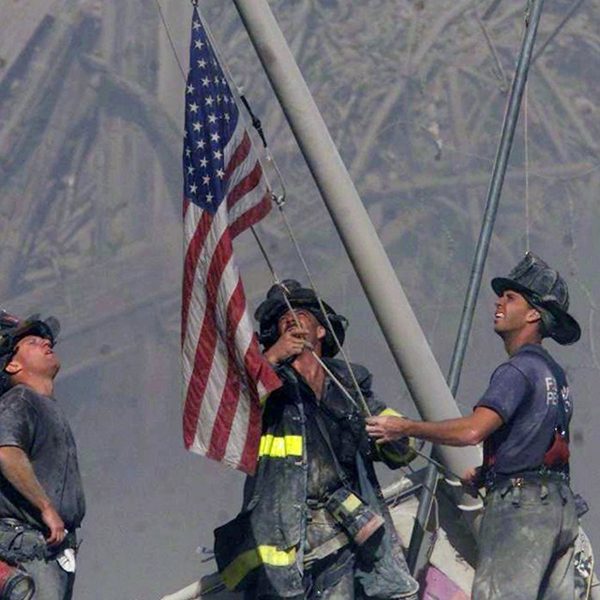 Three firefighters raise the U.S. flag on Sept. 11, 2001 at the World Trade Center in New York City. (Thomas E. Franklin/The Record)