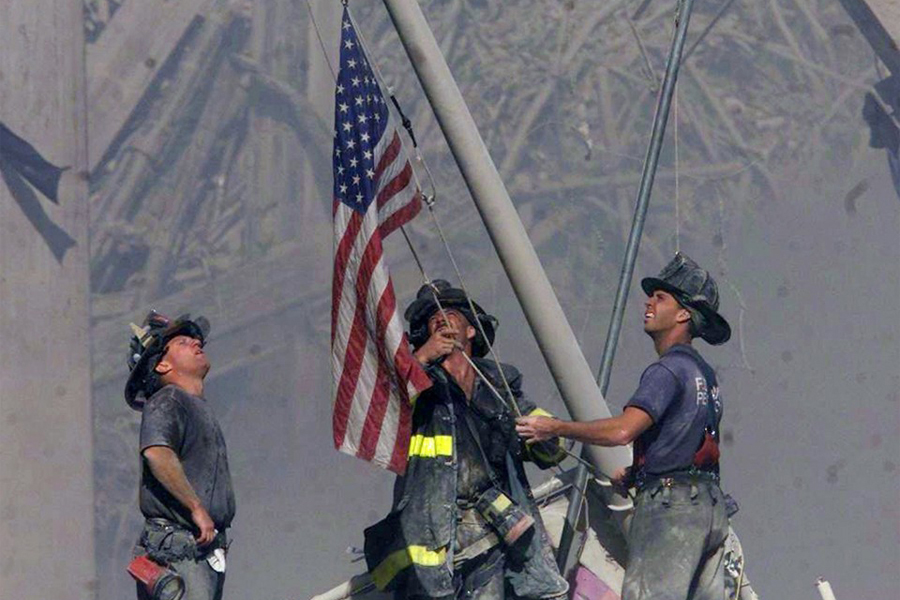 Three firefighters raise the U.S. flag on Sept. 11, 2001 at the World Trade Center in New York City. (Thomas E. Franklin/The Record)