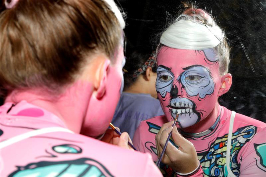 Maddie Hammer backstage doing her own pop zombie makeup for the opening dance routine.