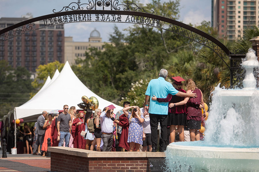 FSU graduates and their loved ones gather at Westcott Fountain to take photos and celebrate commencement July 30, 2021. (FSU Photography Services)