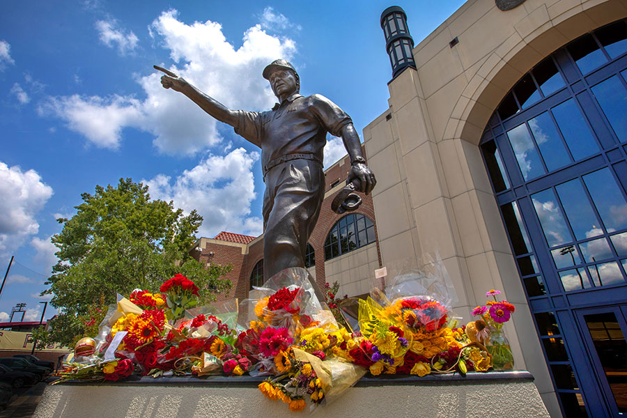 Flowers of remembrance surround the Bobby Bowden statue outside Doak Campbell Stadium after the Hall of Fame coach's passing in August 2021. (FSU Photography Services)