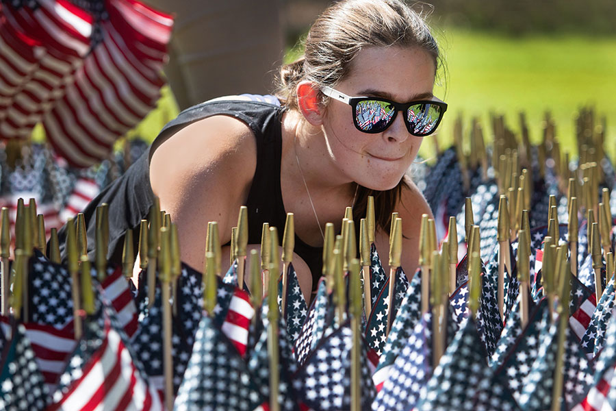 An FSU student places American flags on Mina Jo Powell Green in remembrance of those lost on 9/11 Sept. 10, 2021. (FSU Photography Services)