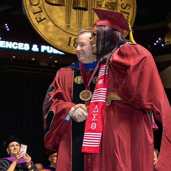 President McCullough congratulates former FSU Trustee and Student Body President Nastassia “Tazzy” Janvier during spring commencement Saturday, April 30, 2022. (FSU Photography Services)