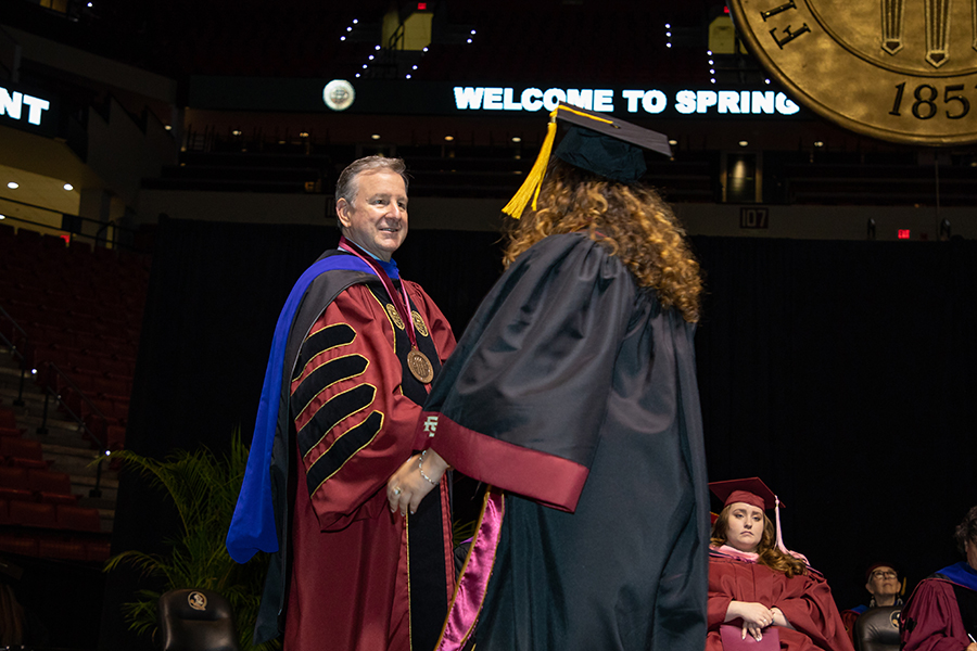President McCullough congratulates a graduate during spring commencement Saturday, April 30, 2022. (FSU Photography Services)