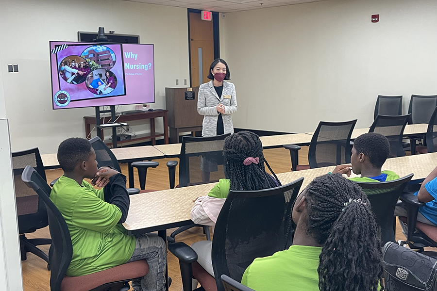 Jing Wang, dean of FSU College of Nursing, welcomes Boys & Girls Clubs of the Big Bend middle- and high school students, sharing that there are excellent opportunities for a career in nursing