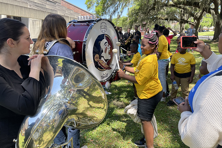 Boys & Girls Clubs of the Big Bend tried various instruments during a hands-on educational program before the PRISM concert.