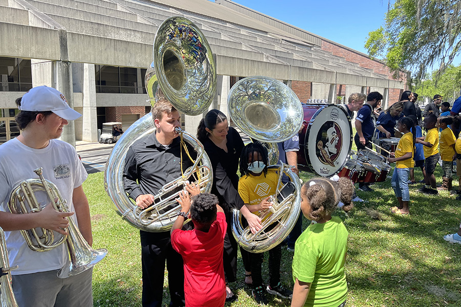 Boys & Girls Clubs of the Big Bend tried various instruments during a hands-on educational program before the PRISM concert.