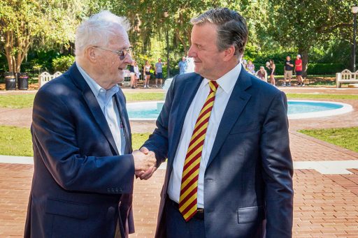 Florida State University President Richard McCullough, right, greets FSU Professor Emeritus Charles Rockwood in front of Westcott Foundation. 