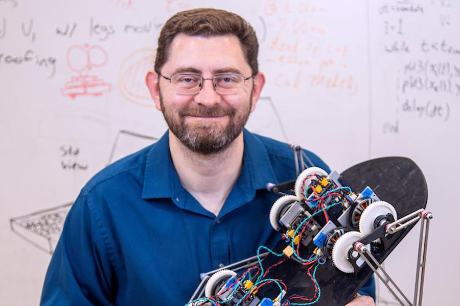 FAMU-FSU College of Engineering Associate Professor of Mechanical Engineering Jonathan Clark is the faculty lead for the college’s NASA Big Idea Challenge team that developed a lunar robot (in his hand) that may one day walk, roll or crawl on the surface of the moon. (M Wallheiser/FAMU-FSU Engineering)