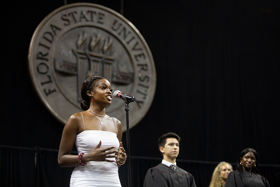 FSU junior Rachel Anderson sings the National Anthem at New Student Convocation on Aug. 21, 2022, at the Donald L. Tucker Civic Center. (FSU Photography Services)