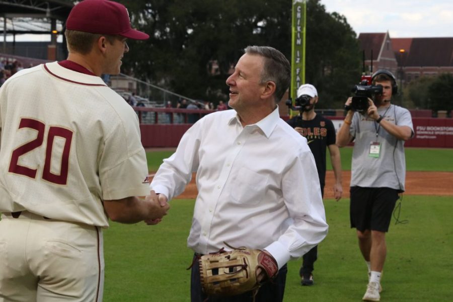 FSU President Richard McCullough greets a player after throwing out the first pitch during a game at Dick Howser Stadium on Feb. 18, 2022. (FSU Photography Services)