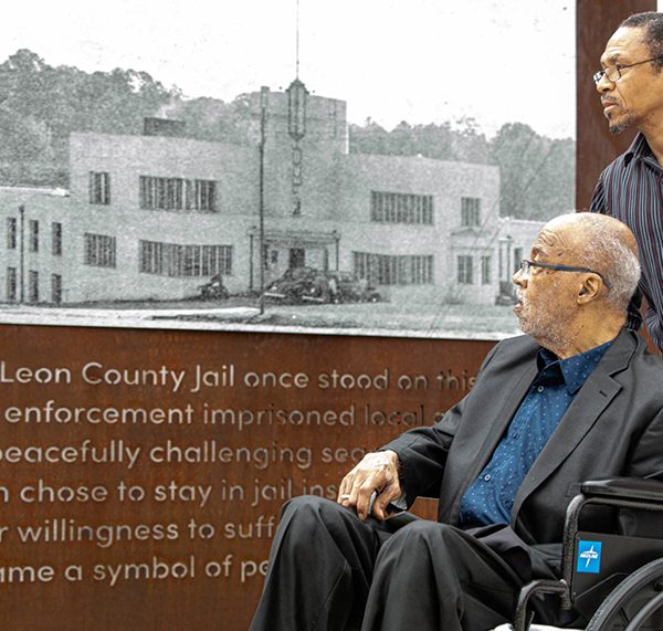Cascades Historical User Group Member Rev. Henry Steele (left) and his brother Rev. Derek Steele reflect upon a photo of the former Leon County Jail. Henry Steele participated in the 1960 jail-in as a civil rights activist.