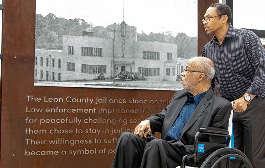 Cascades Historical User Group Member Rev. Henry Steele (left) and his brother Rev. Derek Steele reflect upon a photo of the former Leon County Jail. Henry Steele participated in the 1960 jail-in as a civil rights activist.