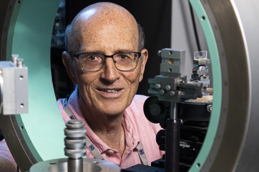 Theo Siegrist, professor of chemical and biomedical engineering at the FAMU-FSU School of Engineering, looks through the Euler cradle of an X-ray diffractometer.  Siegrist uses this machine for structural analysis to study the superconducting properties of compounds composed of niobium, palladium, and sulfur or selenium. This research is funded by the National Science Foundation.  (Mark Wallheiser/FAMU-FSU Faculty of Engineering)