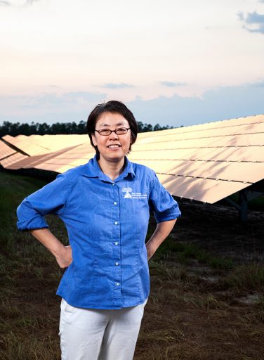 FAMU-FSU College of Engineering Professor Hui "Helen" Li, stands in the solar farm west of the Tallahassee International Airport. (FAMU-FSU College of Engineer/Mark Wallheiser)