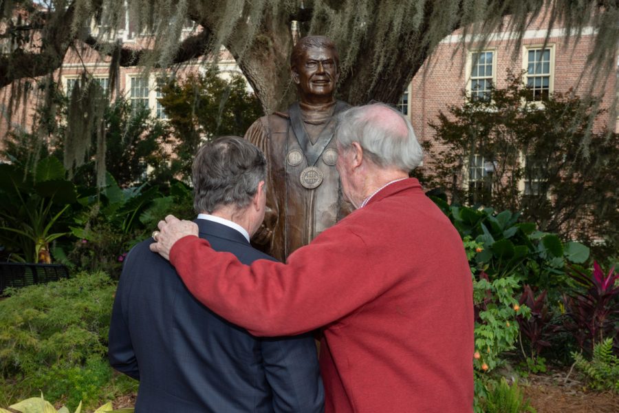 President Richard McCullough and President Emeritus John Thrasher share a moment in front of Thrasher's statue following the dedication ceremony Saturday, Nov. 19, 2022, at Westcott Plaza. (FSU Photography Services)