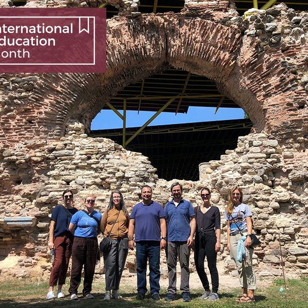 Jones, in mustard shirt, poses with students and colleagues at an archaeological site in Türkiye. (L to R) Maddie Gilmore-Duffey, Sarah Mathiesen, Lynn Jones, host, Brad Hostetler, Caitlin, Emma Huston)