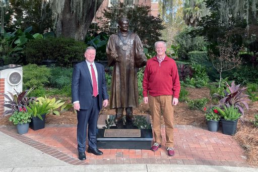 President Richard McCullough and President Emeritus John Thrasher pose in front of Thrasher's statue following the dedication ceremony Saturday, Nov. 19, 2022, at Westcott Plaza.