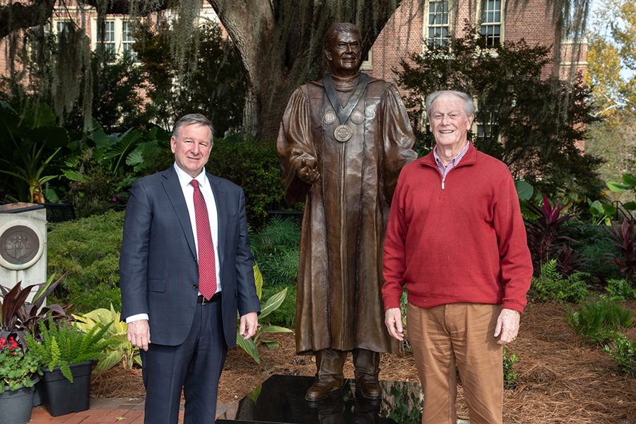 President Richard McCullough and President Emeritus John Thrasher pose in front of Thrasher's statue following the dedication ceremony Saturday, Nov. 19, 2022, at Westcott Plaza. (FSU Photography Services)