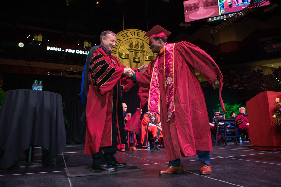 FSU President Richard McCullough with student at the fall commencement ceremony, Dec. 9, 2022. (FSU Photography Services)