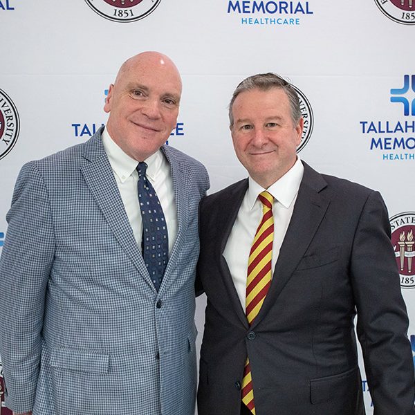 TMH President and CEO Mark O’Bryant and FSU President Richard McCullough pose together after an announcement of designation of land on which the university will build an academic health center held Wednesday, March 8, 2023, in the Dozier Atrium at TMH. (FSU Photography Services)