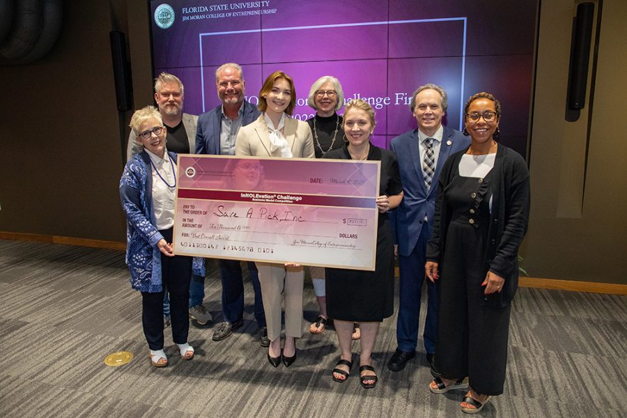 From left: Dean of the Jim Moran College of Entrepreneurship Susan Fiorito, competition judges Lawrence Binder and Mark McNees, winner Mackenzie Taylor, Director of the InNOLEvation® Center for Student Engagement Wendy Plant, judges Sonja Carter, Gary Brand and Tara Hackett.