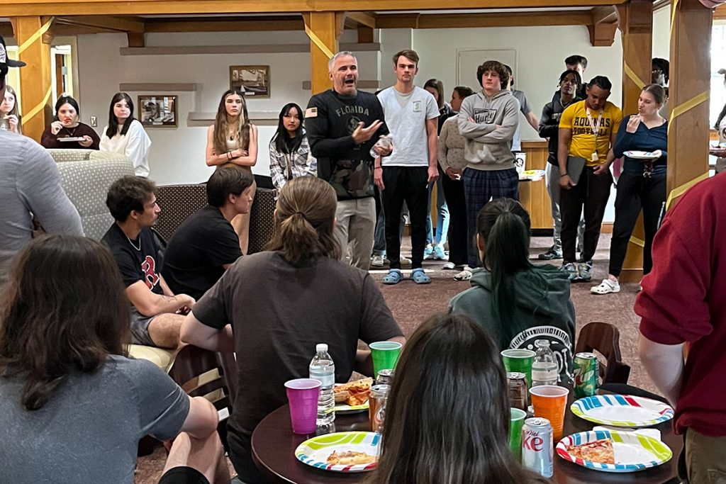 FSU football coach Mike Novell speaks to students in the Bryan Hall Exploratory LLC during a post-spring break pizza party.