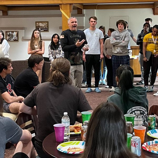 FSU football coach Mike Novell speaks to students in the Bryan Hall Exploratory LLC during a post-spring break pizza party.