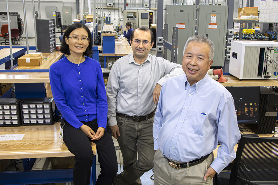From left, Yuan Li, an assistant professor of Electrical and Computer Engineering; Eren Ozguven, associate professor in Civil and Environmental Engineering; and Simon Foo, a professor of Electrical and Computer Engineering at the FAMU-FSU College of Engineering. The trio have been working on the project of studying modular photovoltaic energy systems to help restore power quickly after natural disasters. (Mark Wallheiser/FAMU-FSU College of Engineering)