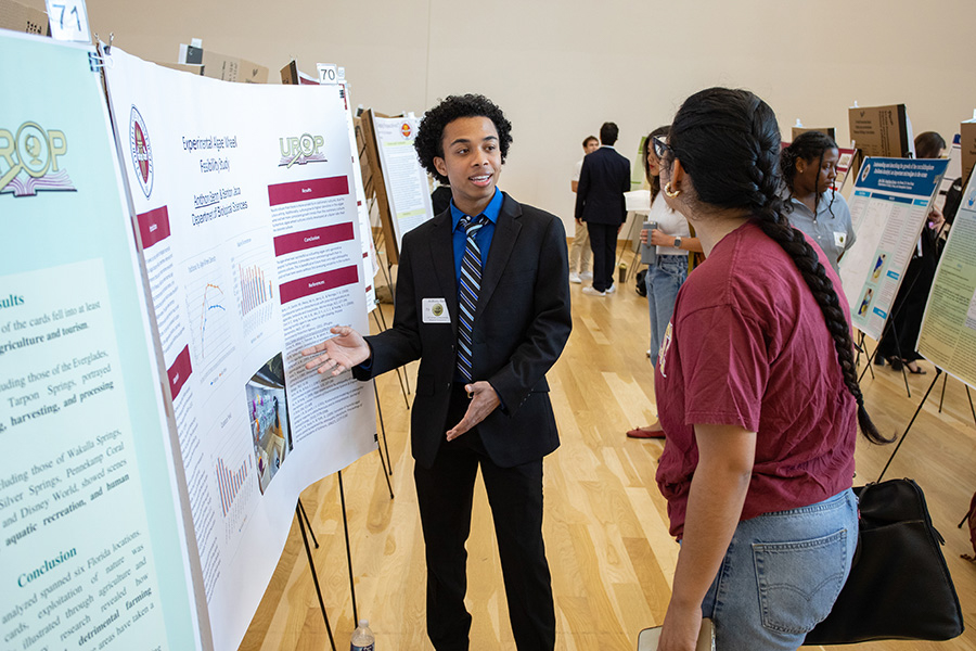 Anthony Benn, a biological sciences major and student researcher, presents his work studying the harmful algal blooms known as red tide at the 23rd annual Undergraduate Research Symposium in the Student Union ballrooms April 6, 2023. (FSU Photography Services)