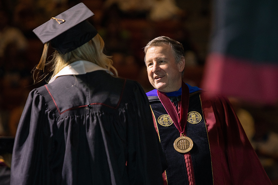 Florida State University's President Richard McCullough and a graduate shake hands during spring commencement Friday, May 5, 2023, at the Donald L. Tucker Civic Center. (FSU Photography Services)