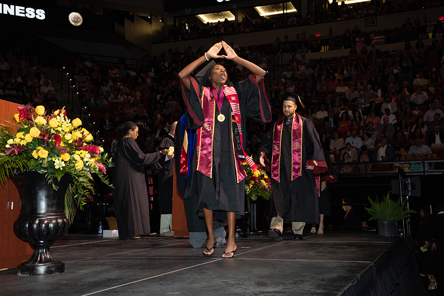 A Florida State University graduate celebrates during spring commencement Friday, May 5, 2023, at the Donald L. Tucker Civic Center. (FSU Photography Services)