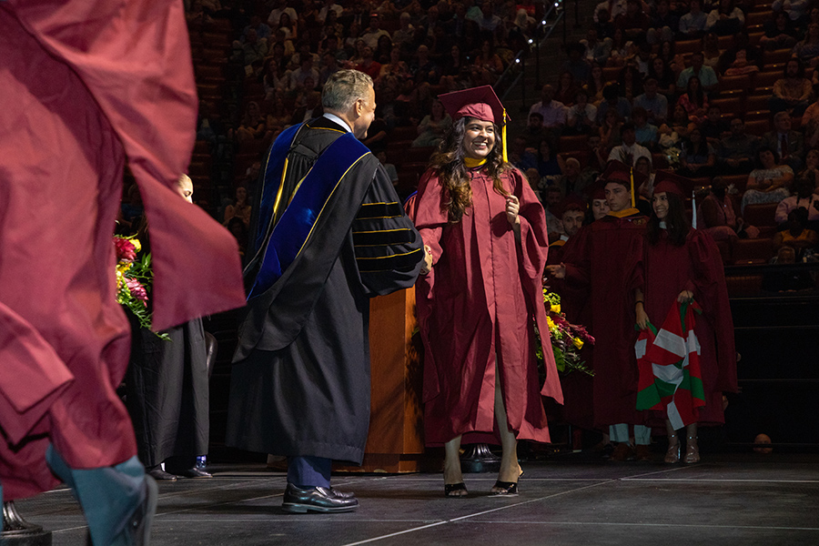 Florida State University College of Arts and Sciences Dean Sam Huckaba and a graduate shake hands during spring commencement Friday, May 5, 2023, at the Donald L. Tucker Civic Center. (FSU Photography Services)