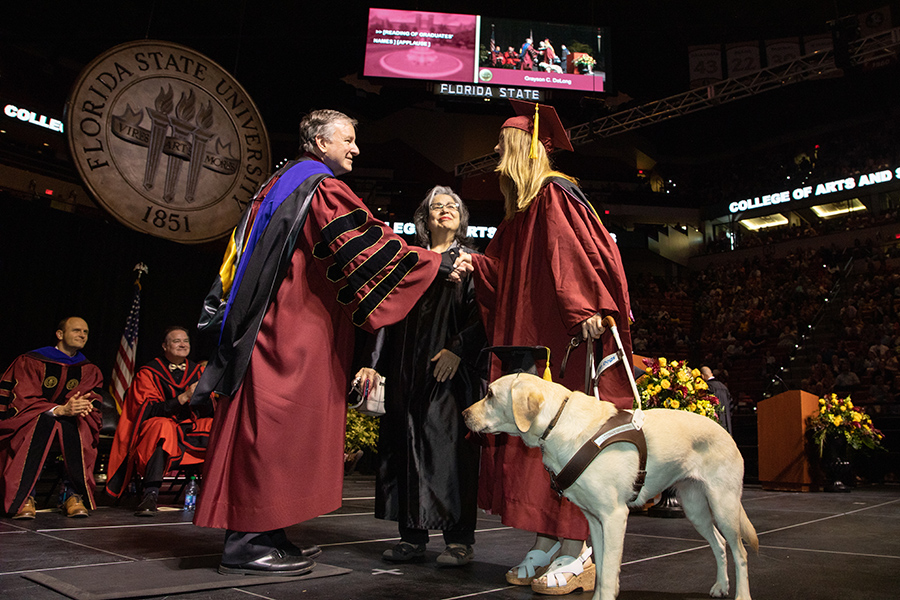 Florida State University's President Richard McCullough and a graduate shake hands during the spring commencement Friday, May 5, 2023, at the Donald L. Tucker Civic Center. (FSU Photography)