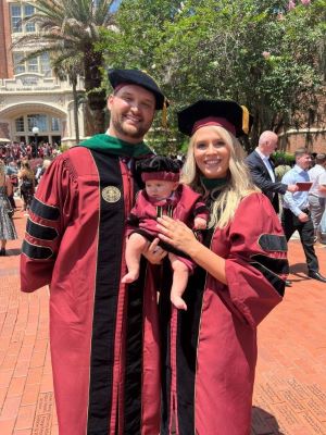 Drs. Jared and Lethia Wainwright with son James,appropriately attired like his parents. (Photo by Robert Thomas of the FSU College of Medicine)