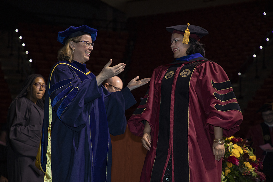 A Florida State University doctoral graduate celebrates with her major professor during a special ceremony Friday, May 5, 2023, at the Donald L. Tucker Civic Center. (FSU Photography)