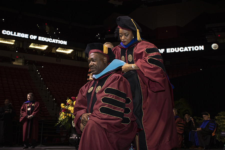 A Florida State University faculty hoods a doctoral graduate during a special ceremony Friday, May 5, 2023, at the Donald L. Tucker Civic Center. (FSU Photography)