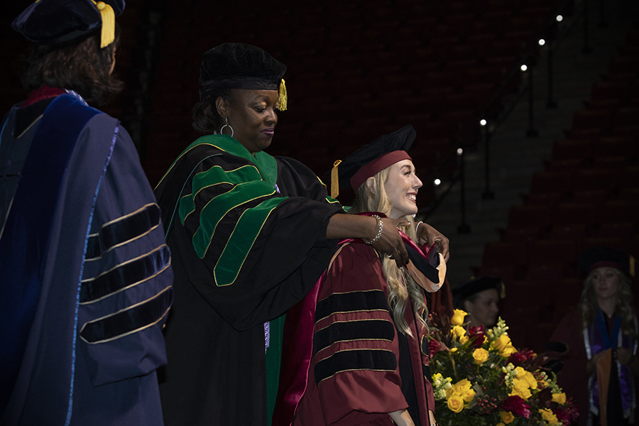 A Florida State University faculty member hoods a doctoral graduate during the university’s spring doctoral hooding ceremony Friday, May 5, 2023, at the Donald L. Tucker Civic Center. (FSU Photography)