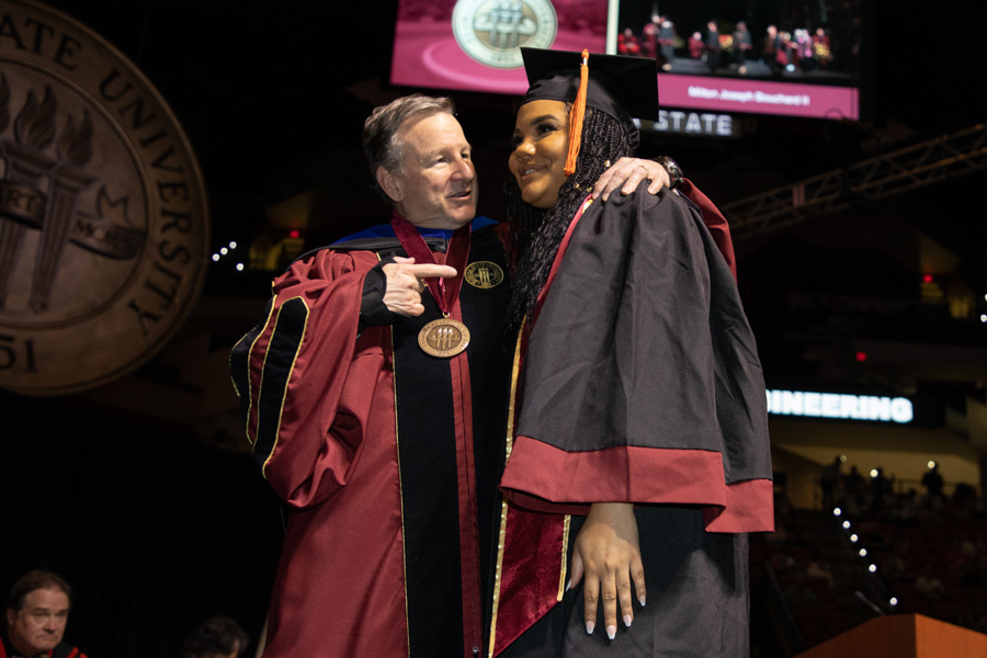 Florida State University's President Richard McCullough poses with a graduate during spring commencement Saturday, May 6, 2023, at the Donald L. Tucker Civic Center. (FSU Photography Services)