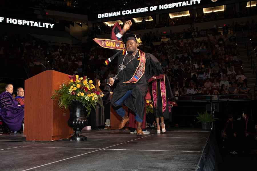 A Florida State University graduate celebrates during the spring commencement Saturday, May 6, 2023, at the Donald L. Tucker Civic Center. (FSU Photography Services)