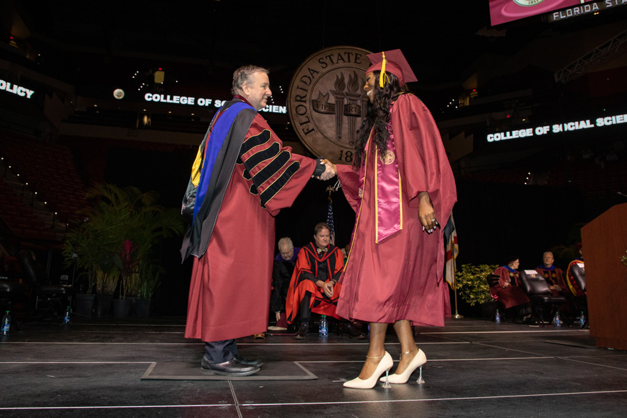 Florida State University's President Richard McCullough and a graduate shake hands during spring commencement Saturday, May 6, 2023, at the Donald L. Tucker Civic Center. (FSU Photography Services)