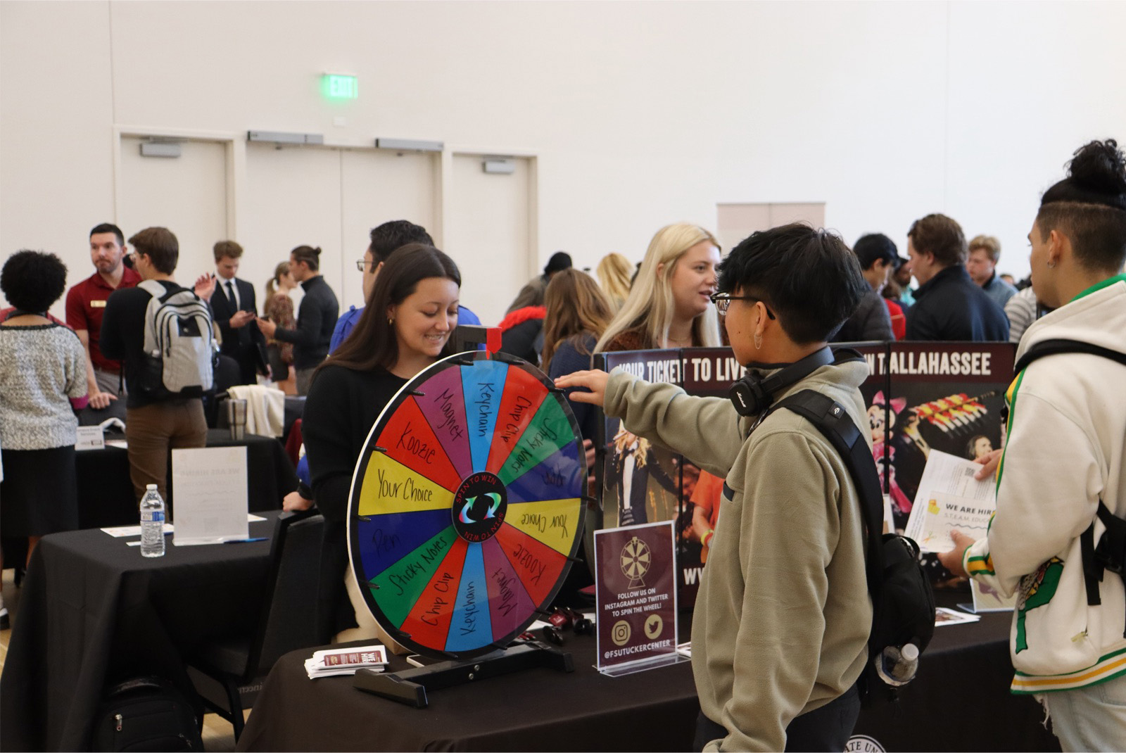 FSU student spinning a wheel to win a prize with an employer at a part-time job fair.