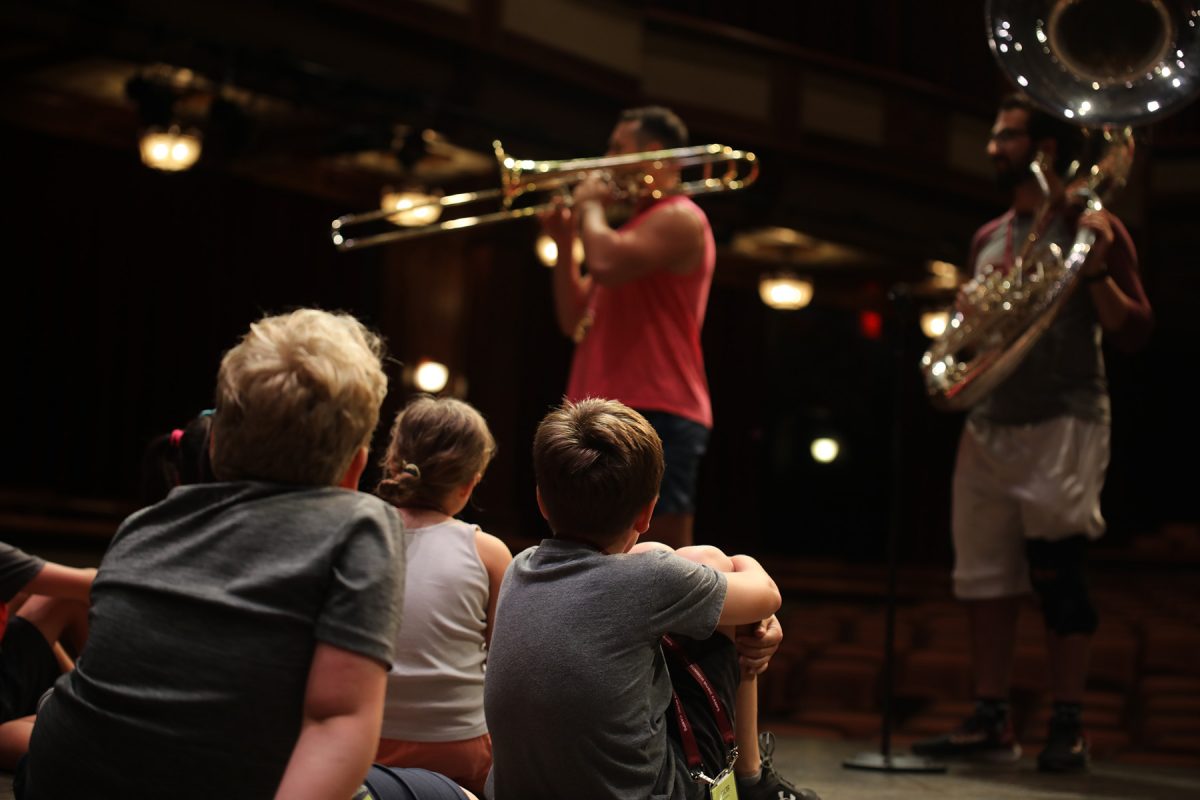 FSU College of Music students captivate the elementary campers as they demonstrate how their instruments work, and answer questions about being a musician. (Photo by Kerry Smith)